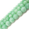 cloudy emerald green dyed jade smooth round beads
